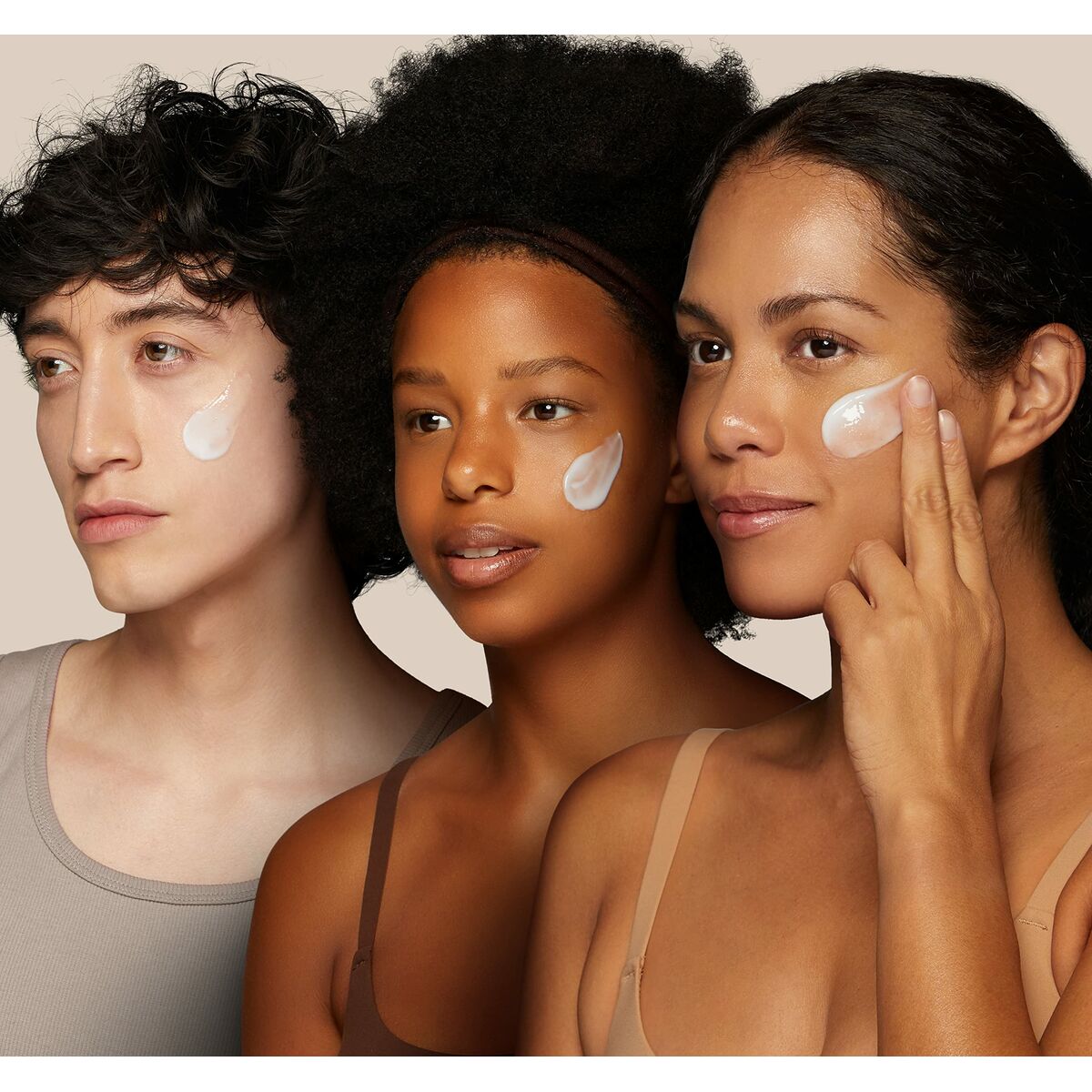 Three diverse individuals applying Elemis Dynamic Resurfacing gel cleanser on their faces for skincare.