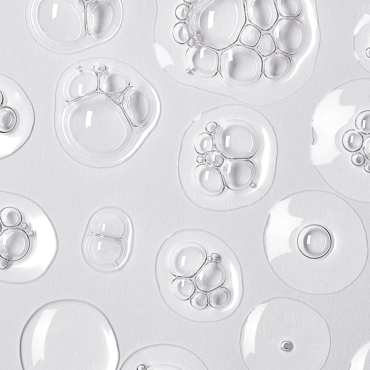 Transparent gel droplets showcasing a light and refreshing texture, ideal for skin serums and cosmetics.