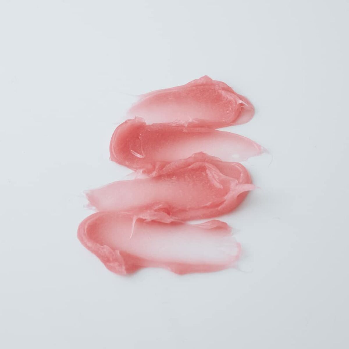 Textured swatches of pink cream makeup on a white surface for Shiseido SYNCHRO SKIN.