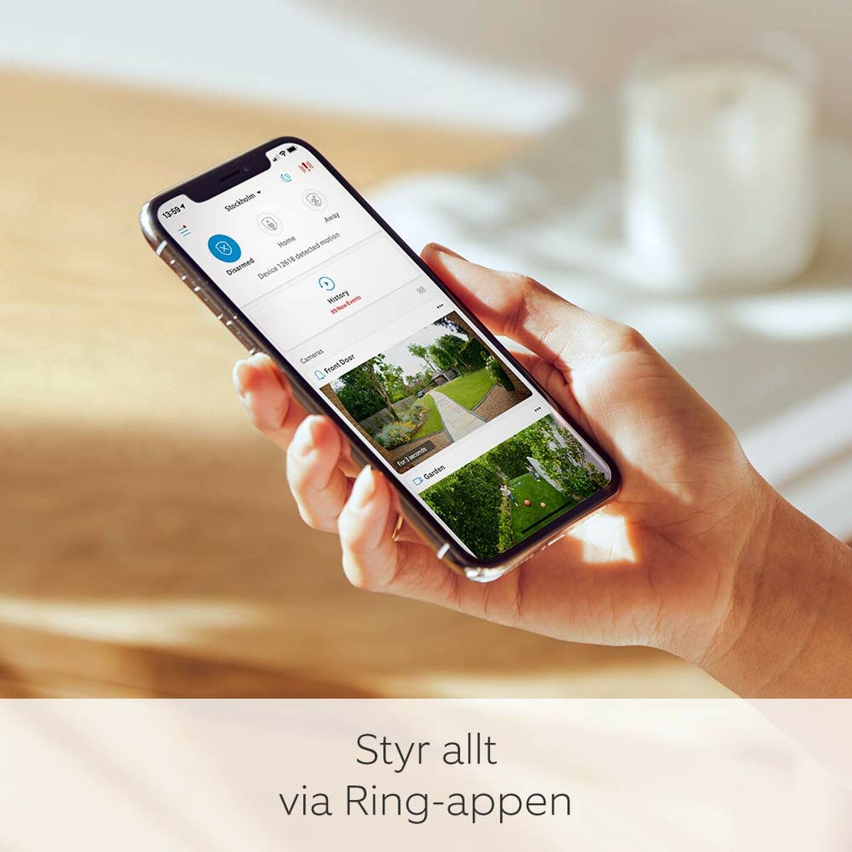 Person using Ring app on smartphone to monitor home security features.