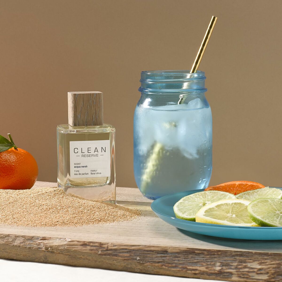 Parfum Femme Clean EDP bottle next to a fresh fruit display and a refreshing drink, showcasing a vibrant lifestyle.