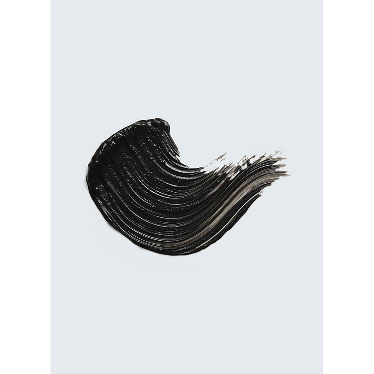 Swatch of black eyeshadow from Estee Lauder Turbolash, showcasing its smooth, creamy texture on a light background.