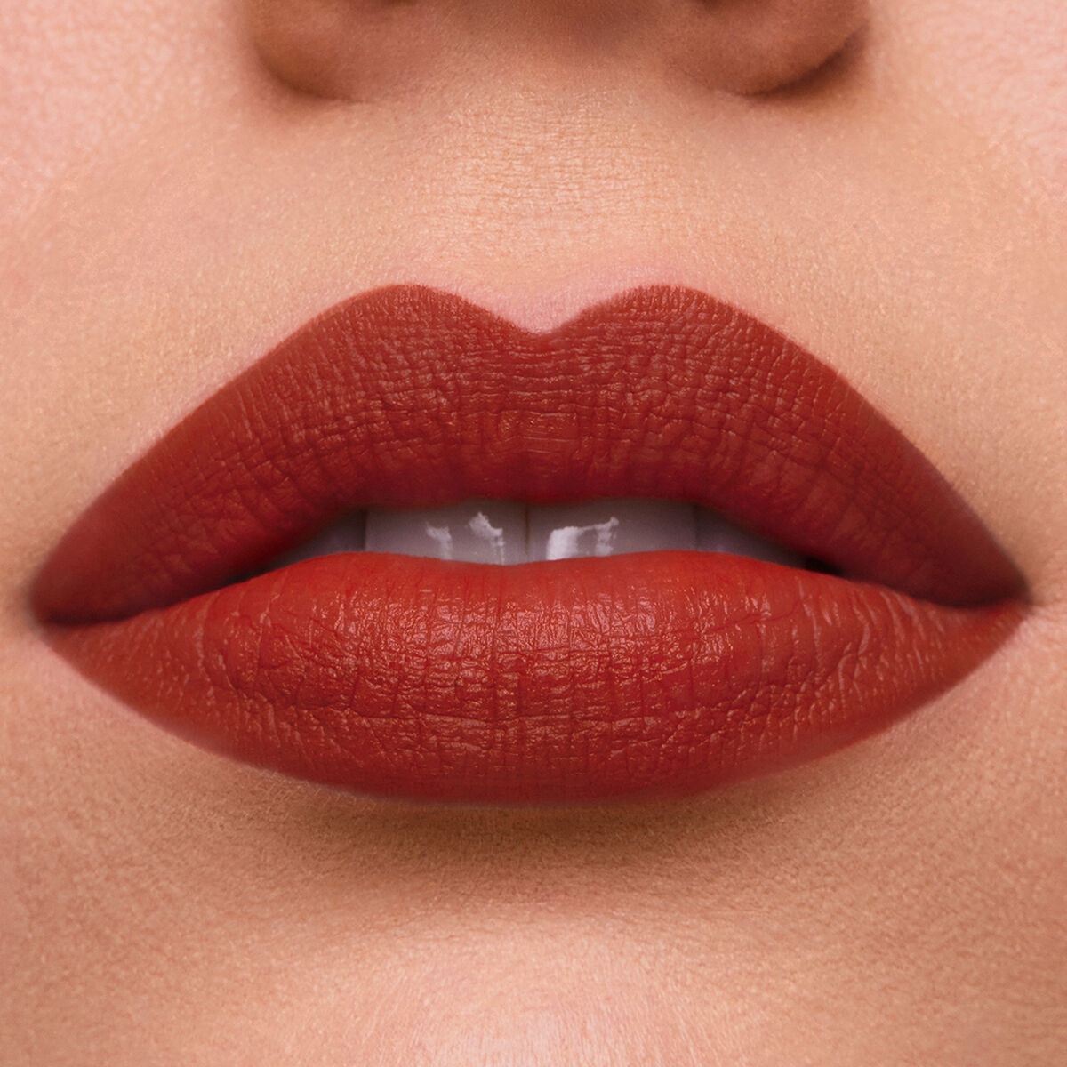 Close-up of lips wearing Estee Lauder Pure Color lipstick in Persuasive, showcasing a rich, creamy texture.