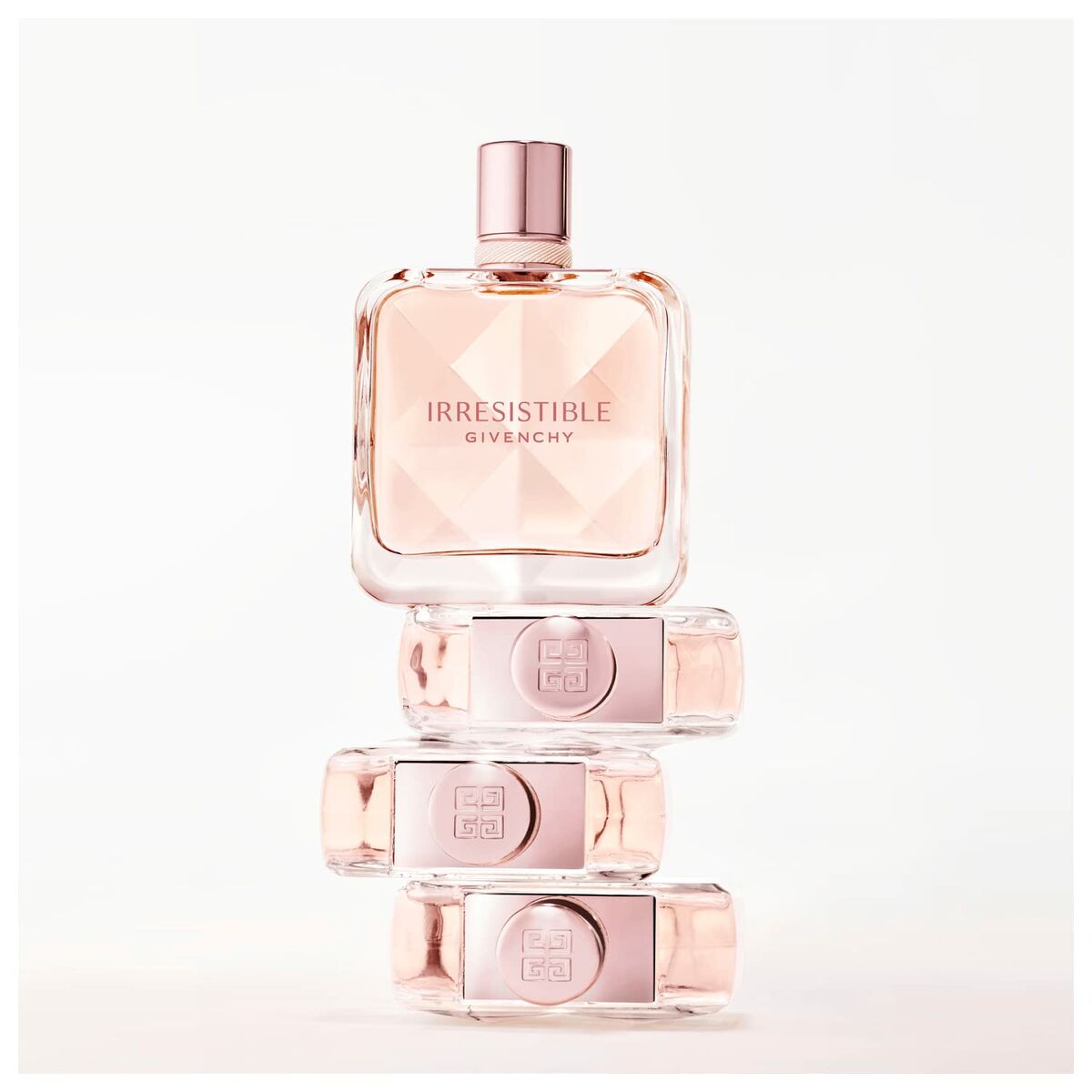 Irresistible Givenchy EDT 50ml perfume bottle stacked elegantly, showcasing its unique design and soft pink hue.