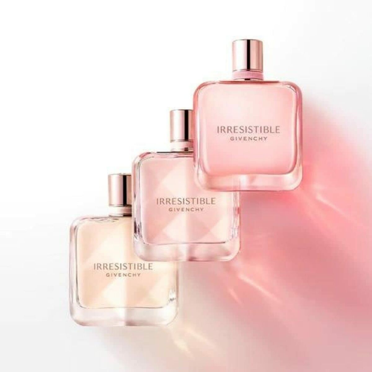 Bottles of Givenchy Irrésistible perfume displayed elegantly, showcasing the feminine fragrance collection.