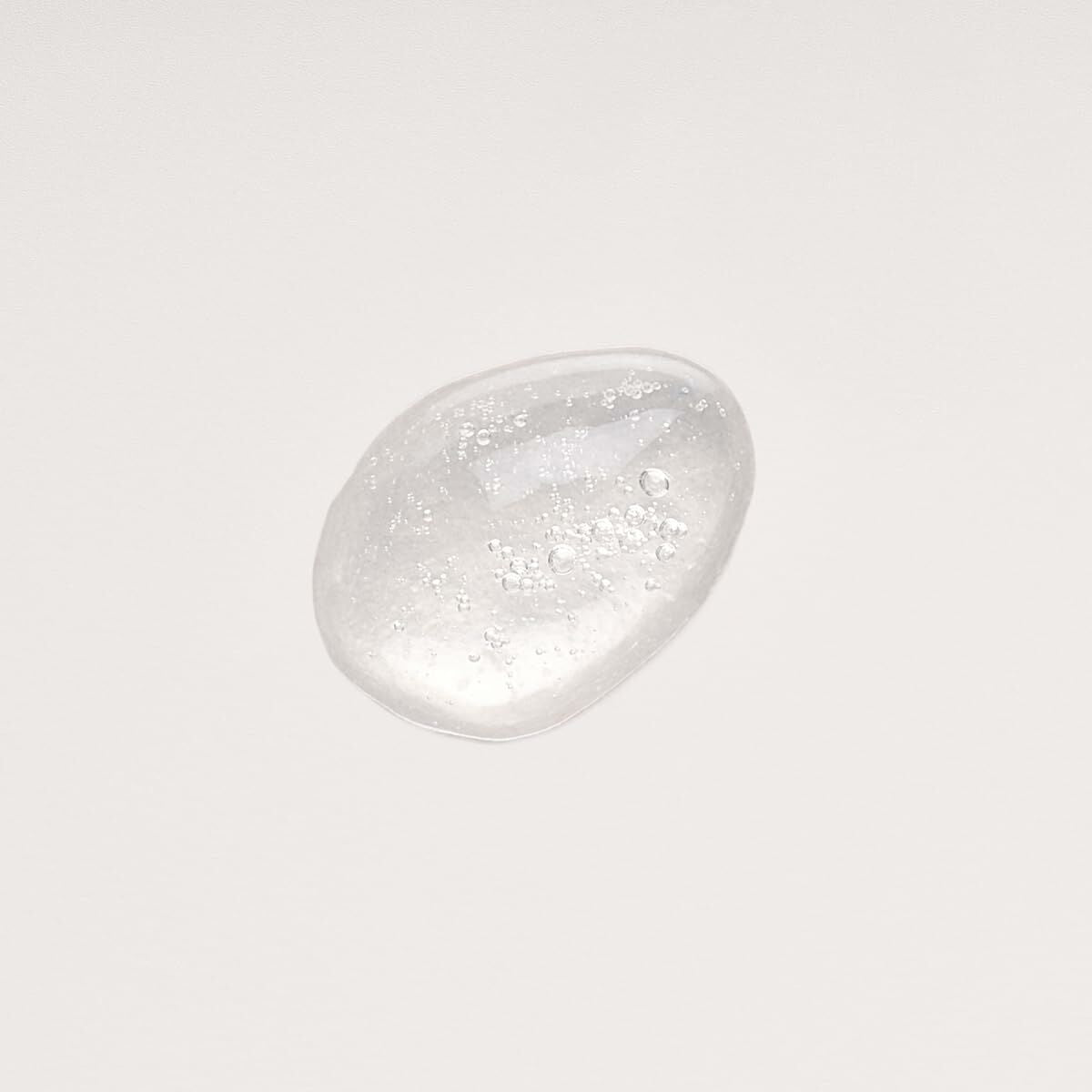 Démaquillant visage Melvita BOUQUET FLORAL DETOX, gel transparent avec des bulles, sur fond blanc.