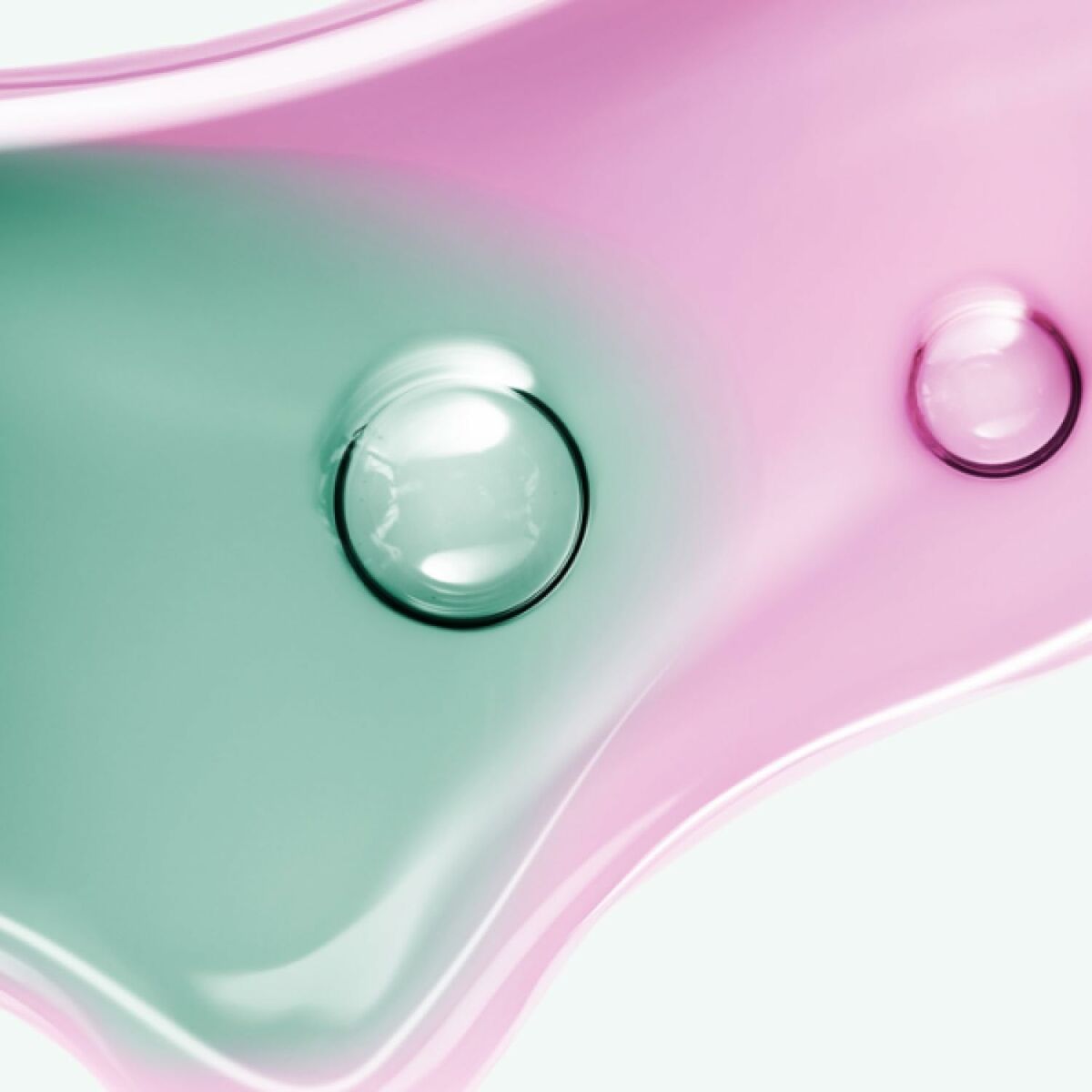 Textured close-up of pink and green gel droplets, highlighting the refreshing essence of Melvita NECTAR PUR face cream.