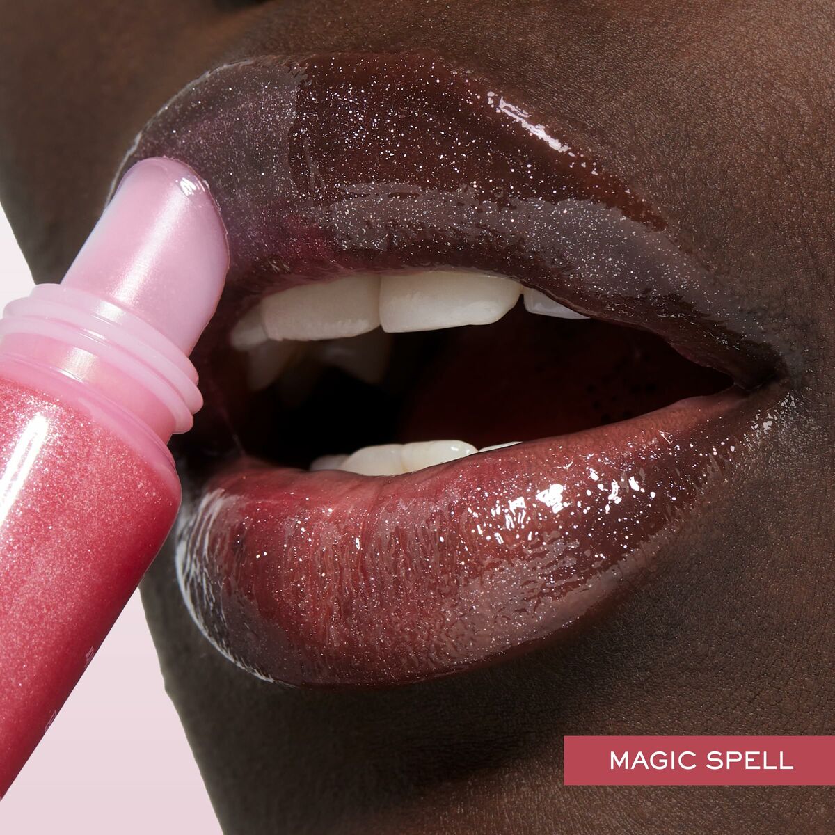 Close-up of lips applying Lancôme Juicy Tubes lip gloss in shade Magic Spell, showcasing glossy shine and vibrant color.