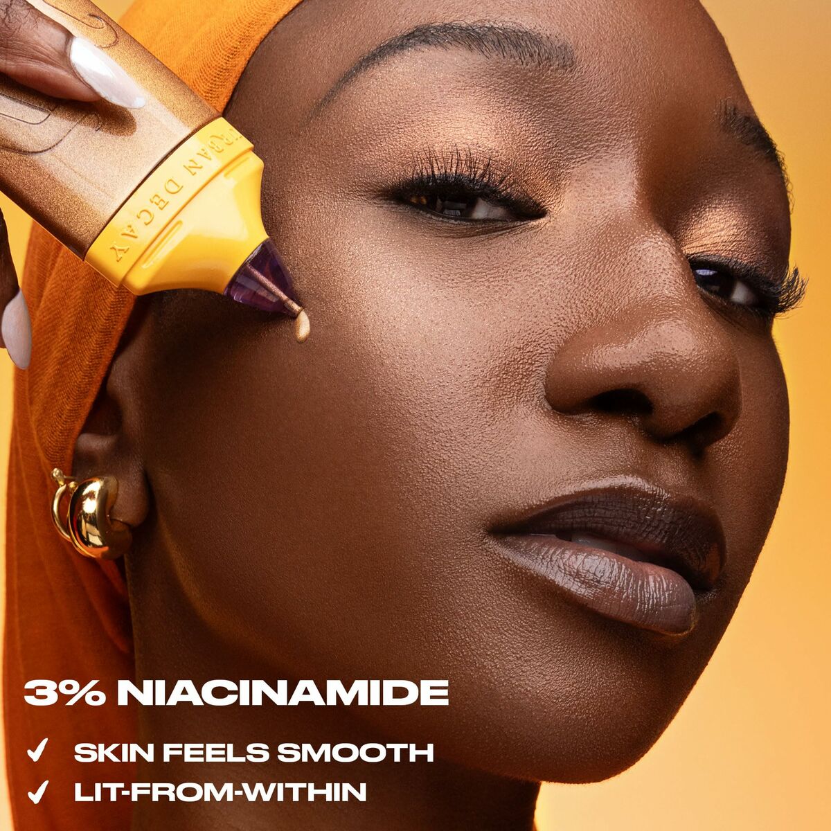 Model using Urban Decay makeup with 3% niacinamide, showcasing smooth, glowing skin.