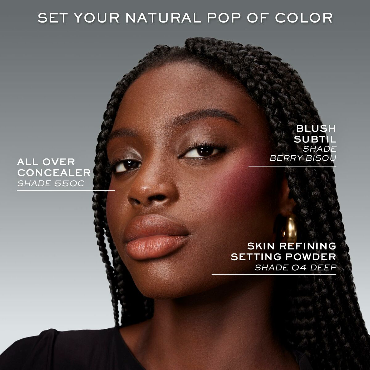 Close-up of a model showcasing Lancôme makeup products: concealer shade 550C, blush shade Berry Bisou, and setting powder shade 04 Deep.