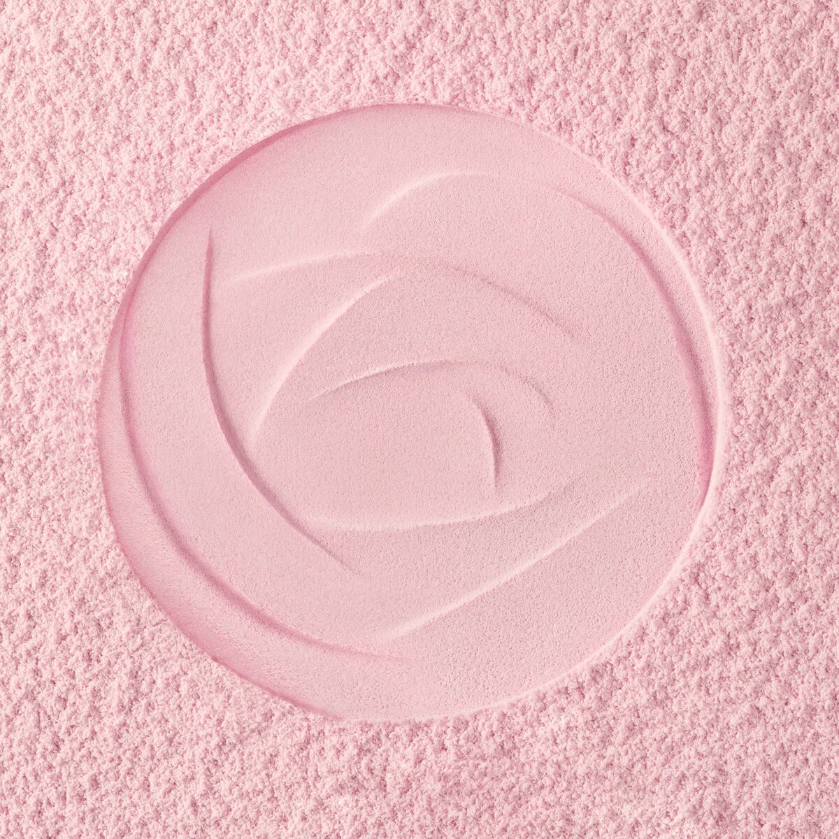 Rose embossed pattern on soft pink makeup powder surface