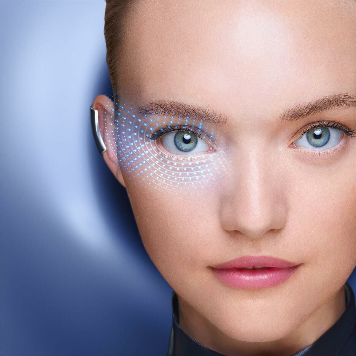 Close-up of a woman's face showcasing bright eyes, promoting Lancôme GÉNIFIQUE eye contour cream for youthful skin.