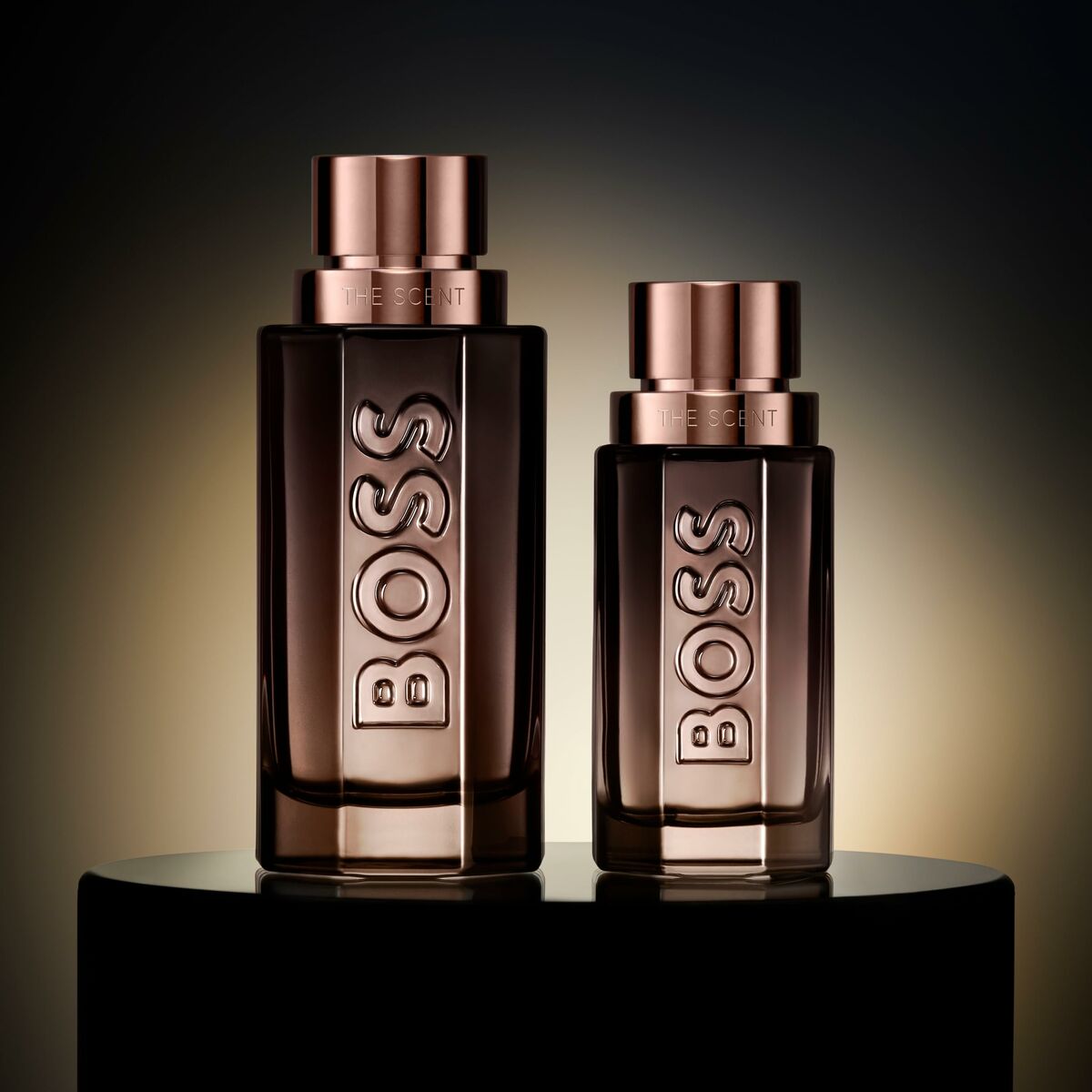 Bottles of Hugo Boss The Scent unisex perfume showcasing elegant design and branding on a dark background.