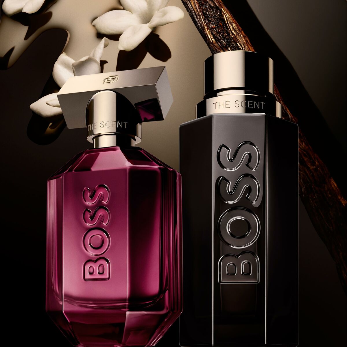 BOSS The Scent for Her and for Him perfumes displayed elegantly against a dark background with floral accents.