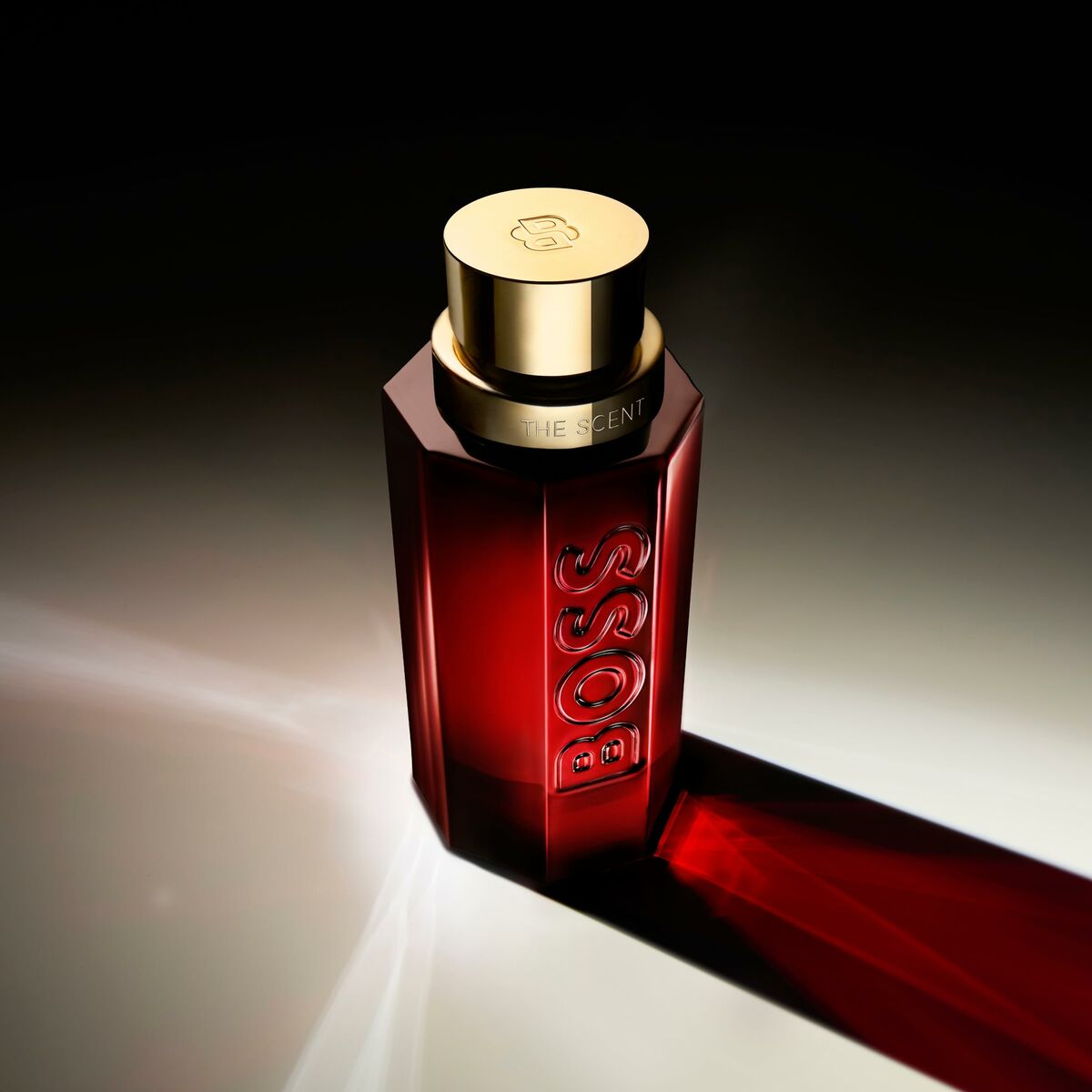 Hugo Boss The Scent men's perfume 100 ml in elegant bottle with golden cap and dark red design.