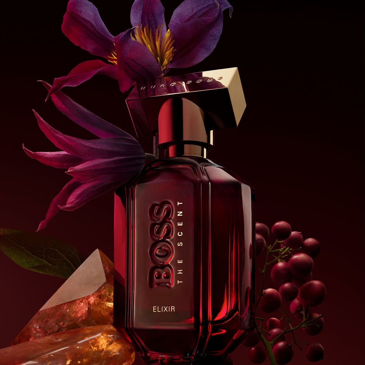Parfum Unisexe Hugo Boss The Scent Elixir 50 ml, flacon élégant avec fleurs et fruits, packaging luxueux.