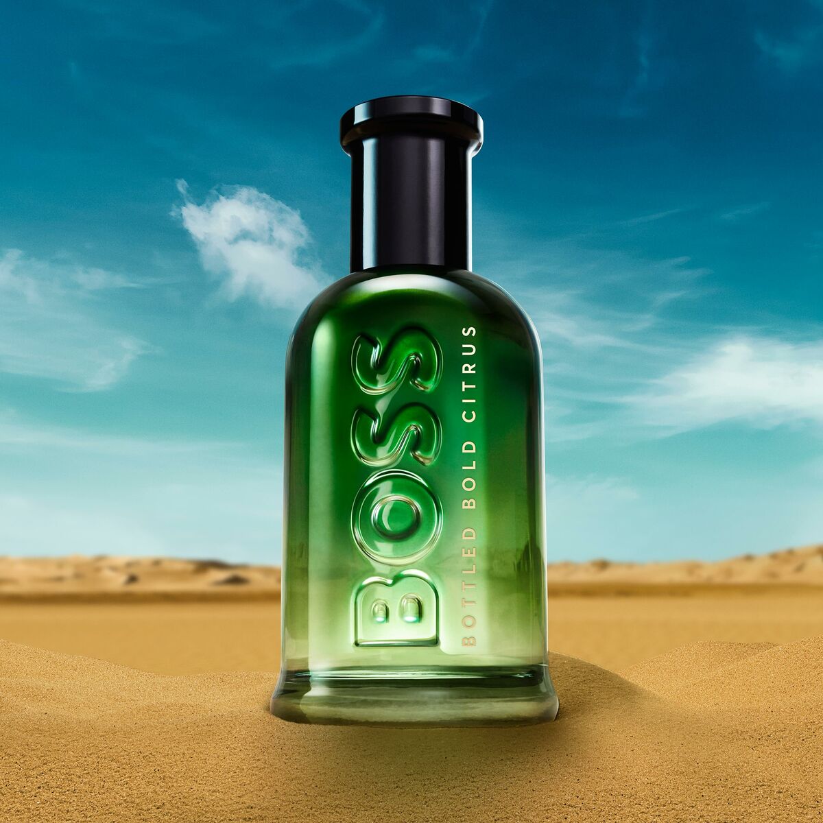 Parfum Homme BOSS BOSS BOTTLED Bold Citrus, en flacon vert sur fond désertique, 100ml.