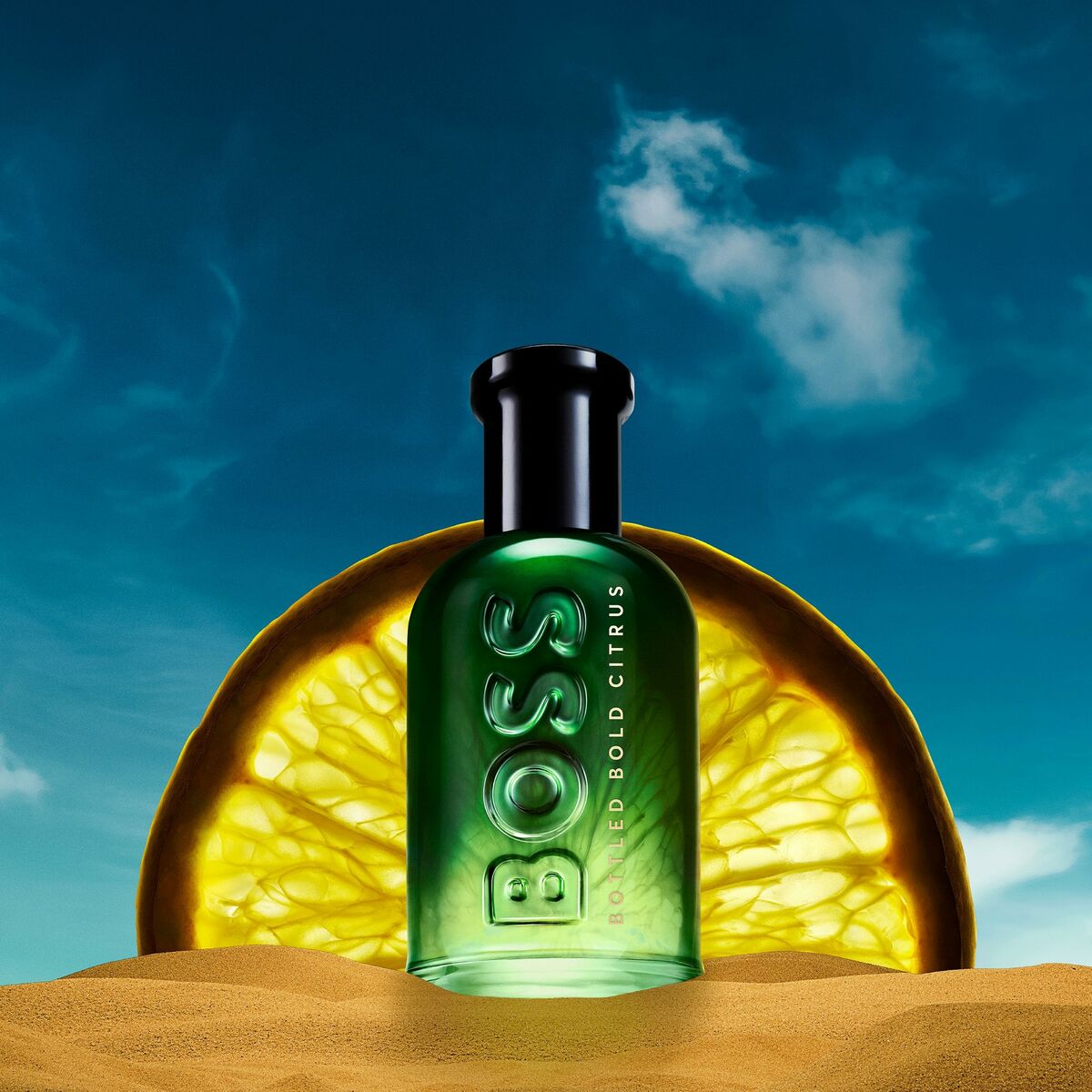 BOSS BOTTLED fragrance bottle with citrus backdrop, showcasing luxury and freshness in a desert setting.