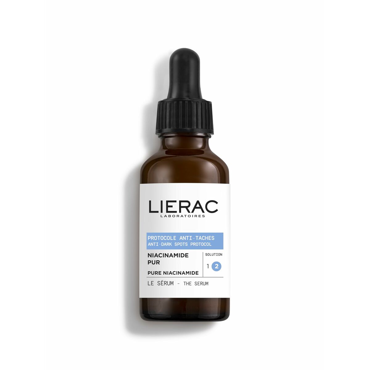 Sérum visage Lierac avec pipette, flacon marron, niacinamide pur pour soins esthétiques anti-taches.