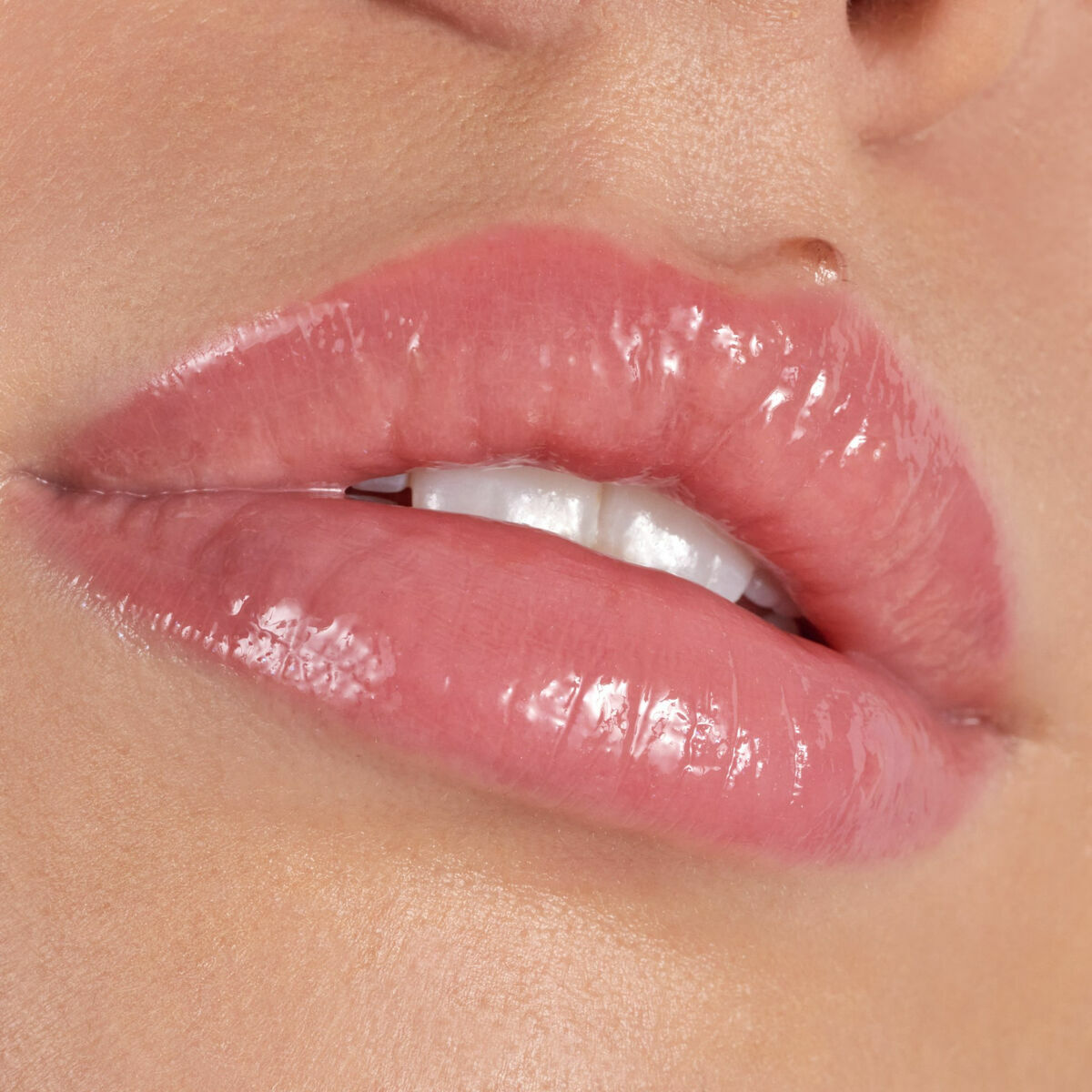 Close-up of glossy lips showcasing Catrice Plump It Up Liquid Lipstick's shiny finish.