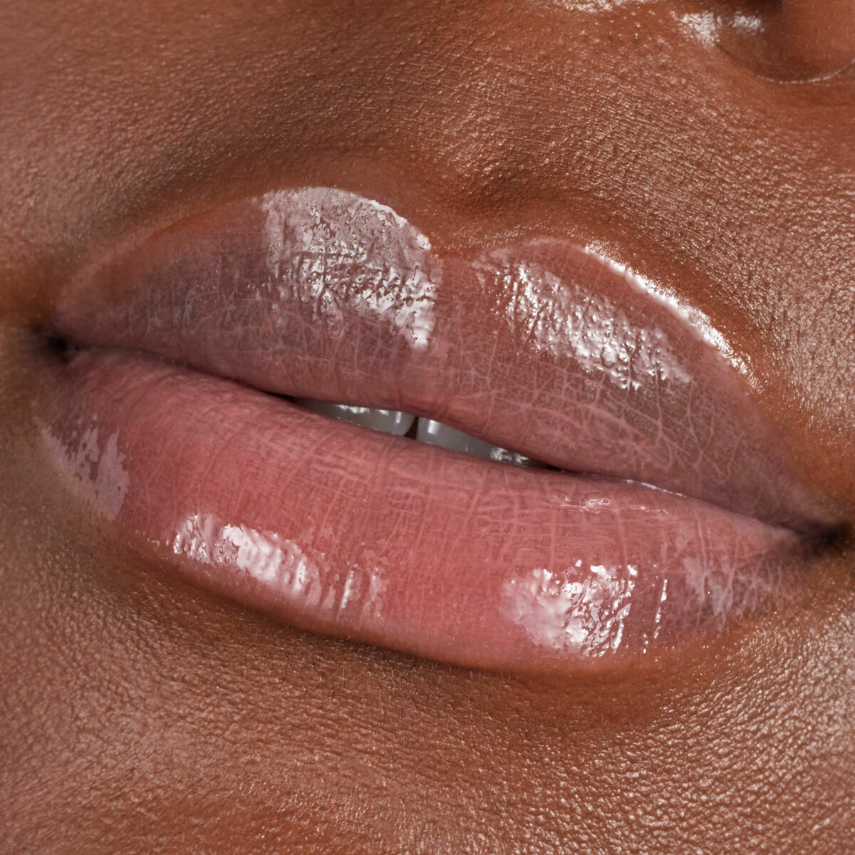 Close-up of glossy lips featuring liquid lipstick for a plump, luminous finish from Catrice.