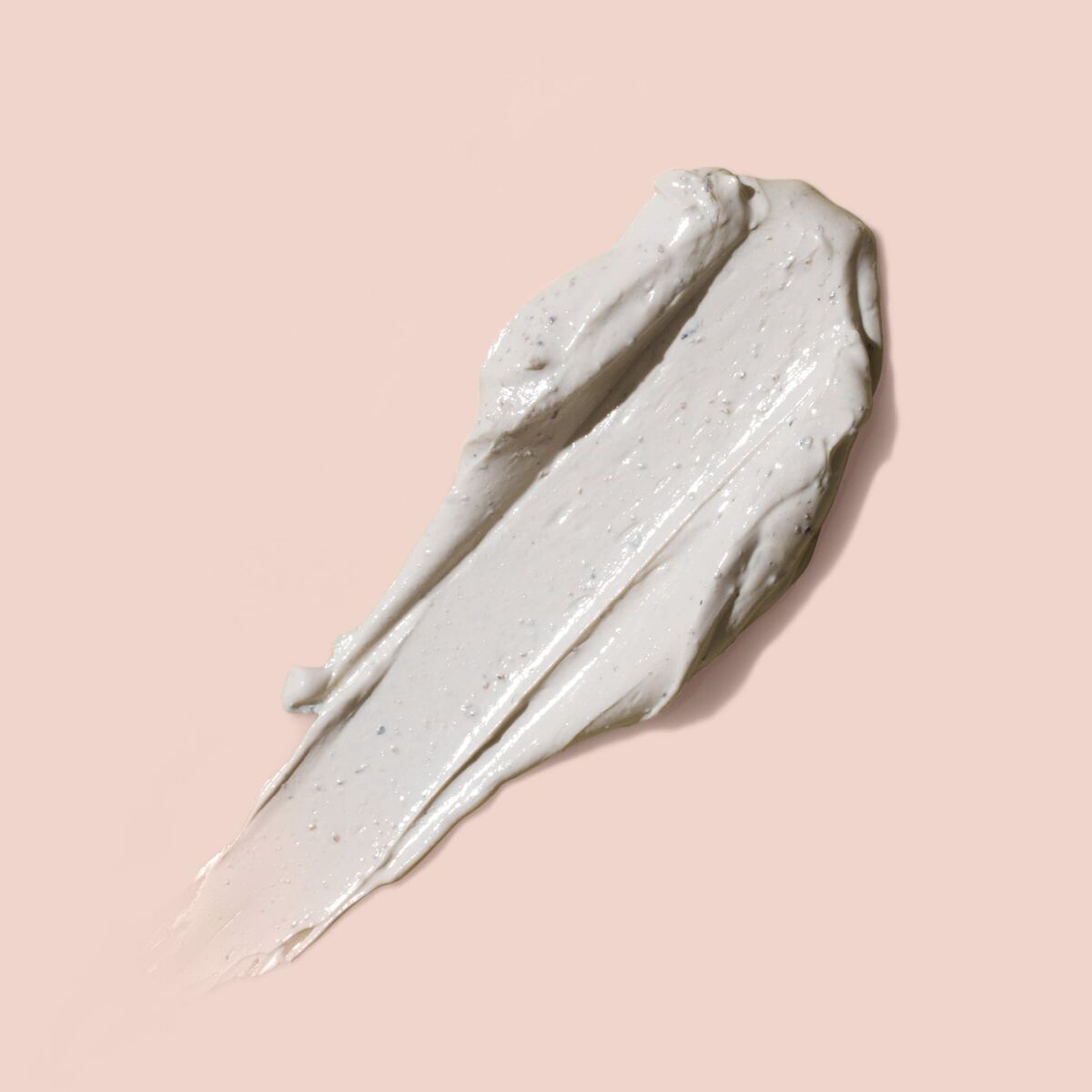 Texture of Eve Lom cleansing and regenerating mask 0028_7880 on a soft pink background.