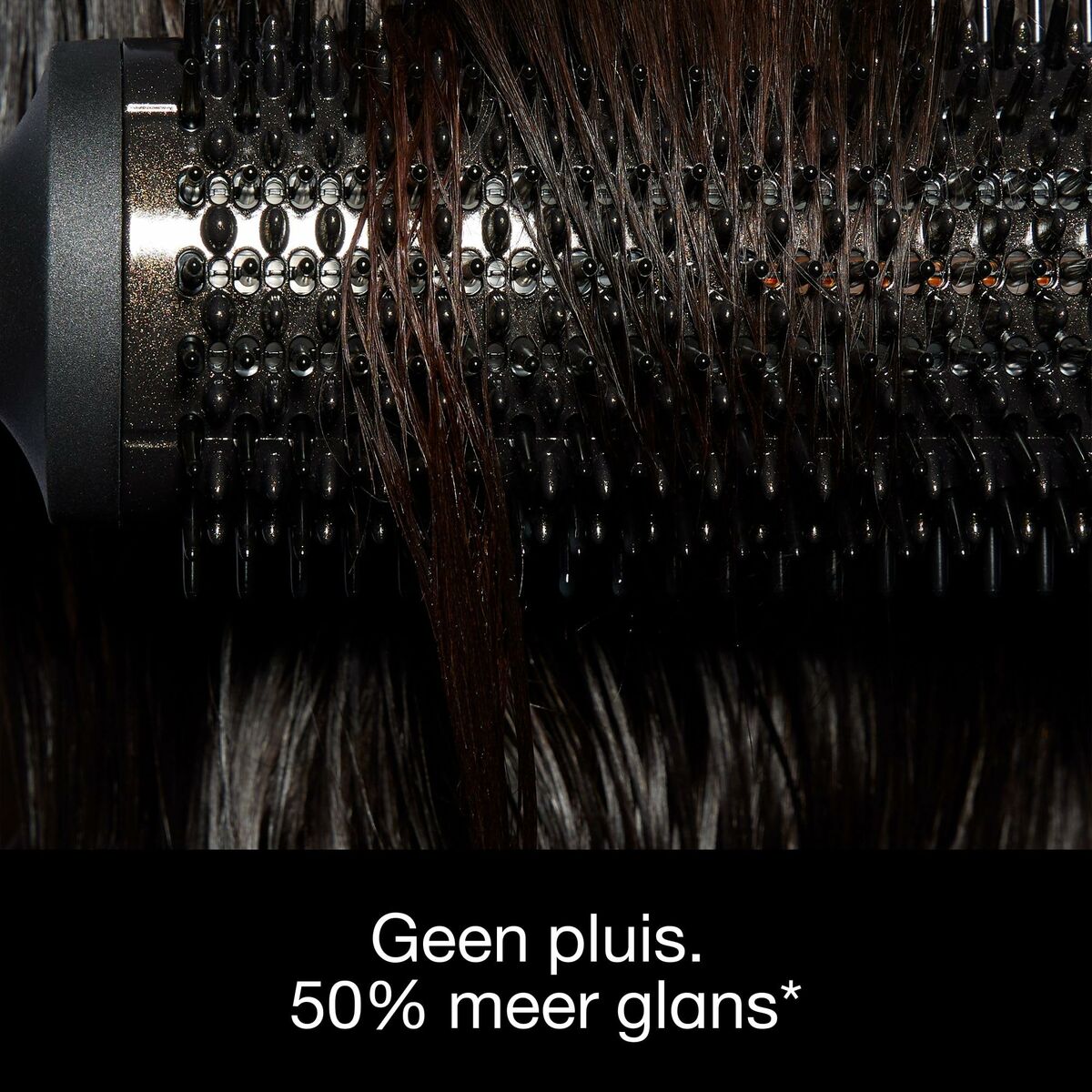Close-up of a hairbrush showing sleek hair with improved shine and no frizz.