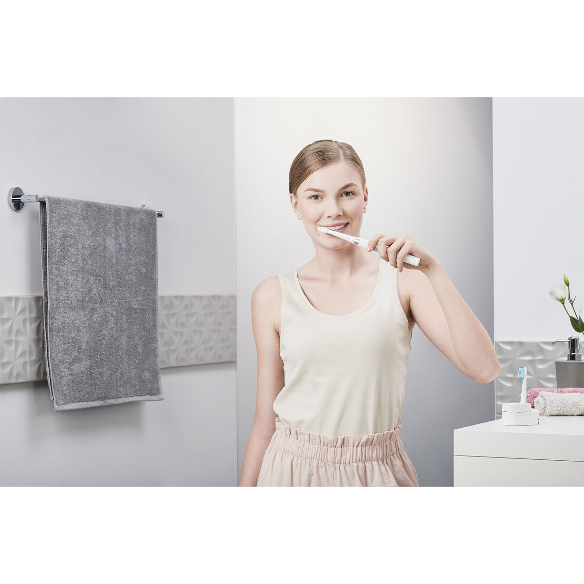 Model using the Panasonic electric toothbrush WEW0974W503 in a modern bathroom setting.