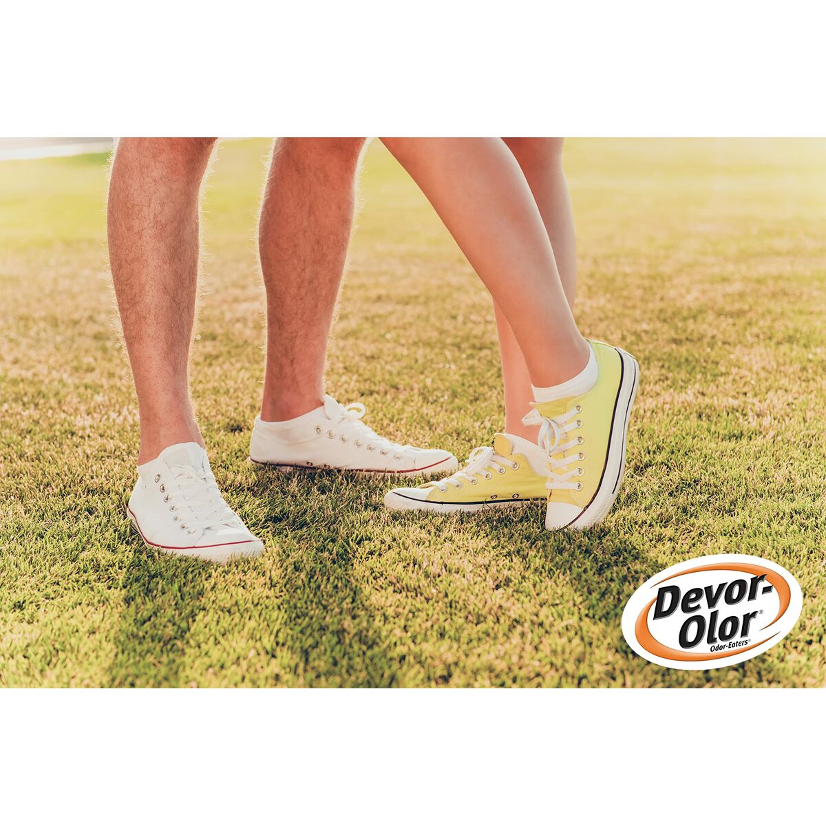 Couple wearing colorful Devor-Olor sneakers on grass, showcasing casual style and summer vibes.