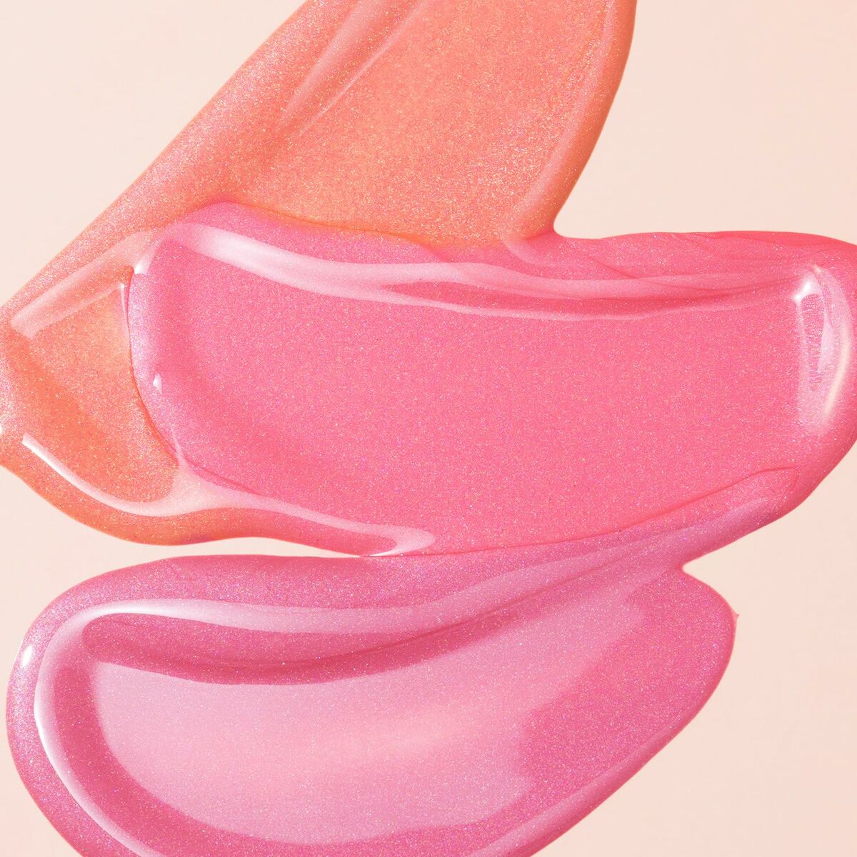 Textured swatches of shimmering pink makeup, showcasing fluid, vibrant colors from the Collistar makeup set.