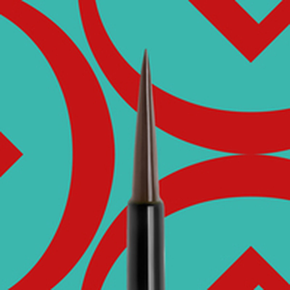 Close-up of Collistar makeup brush tip against a vibrant blue and red geometric background.