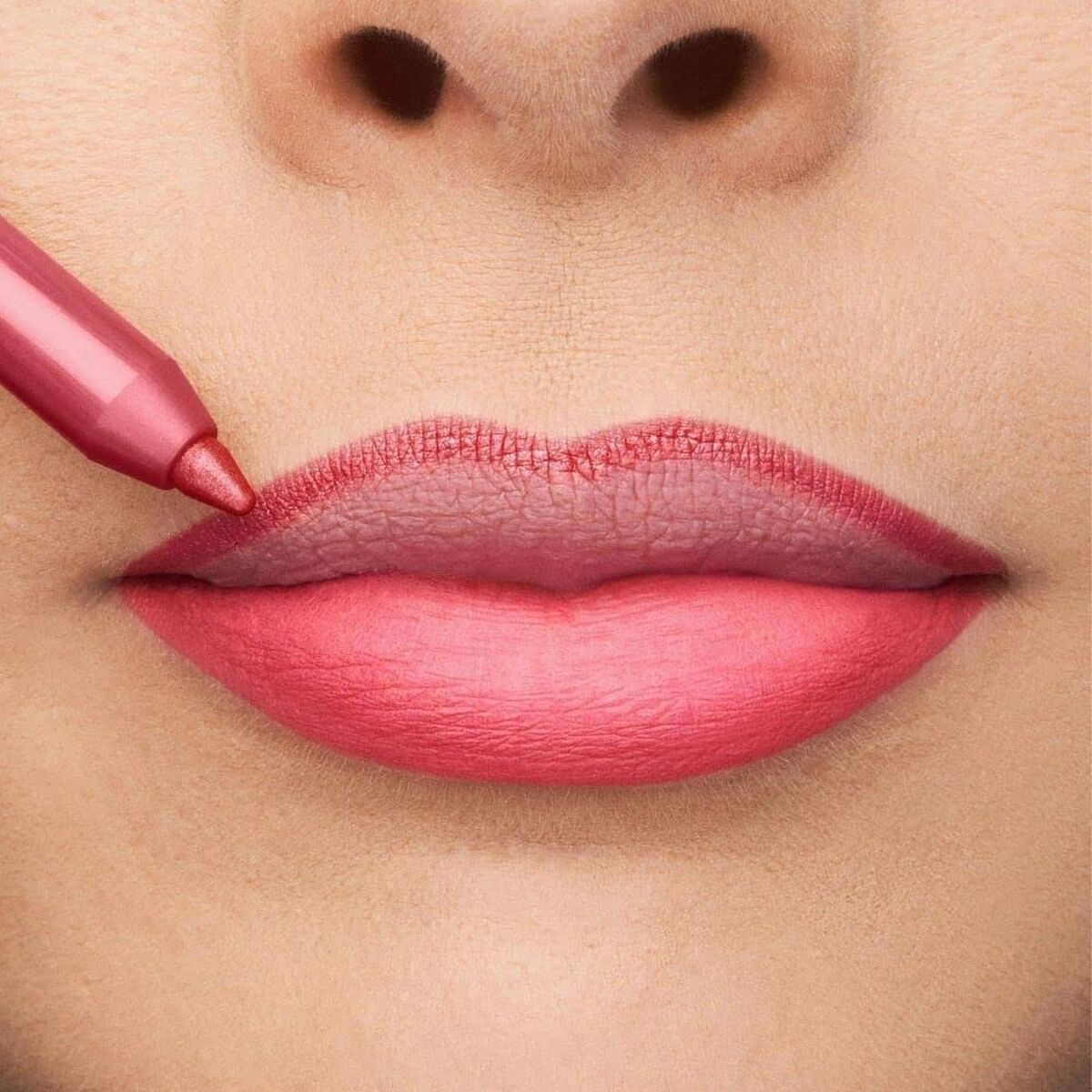 Close-up of lips being lined with a pink lip pencil, showcasing a luscious pink lipstick shade.