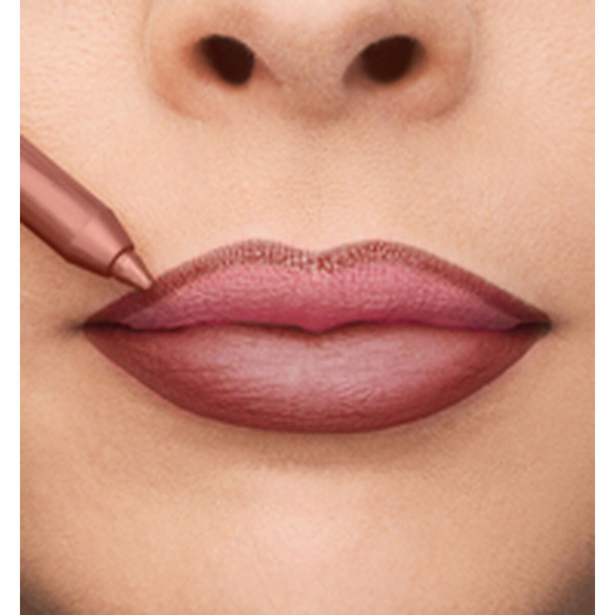 Application of Collistar lipstick on pink lips with a lip liner pencil.
