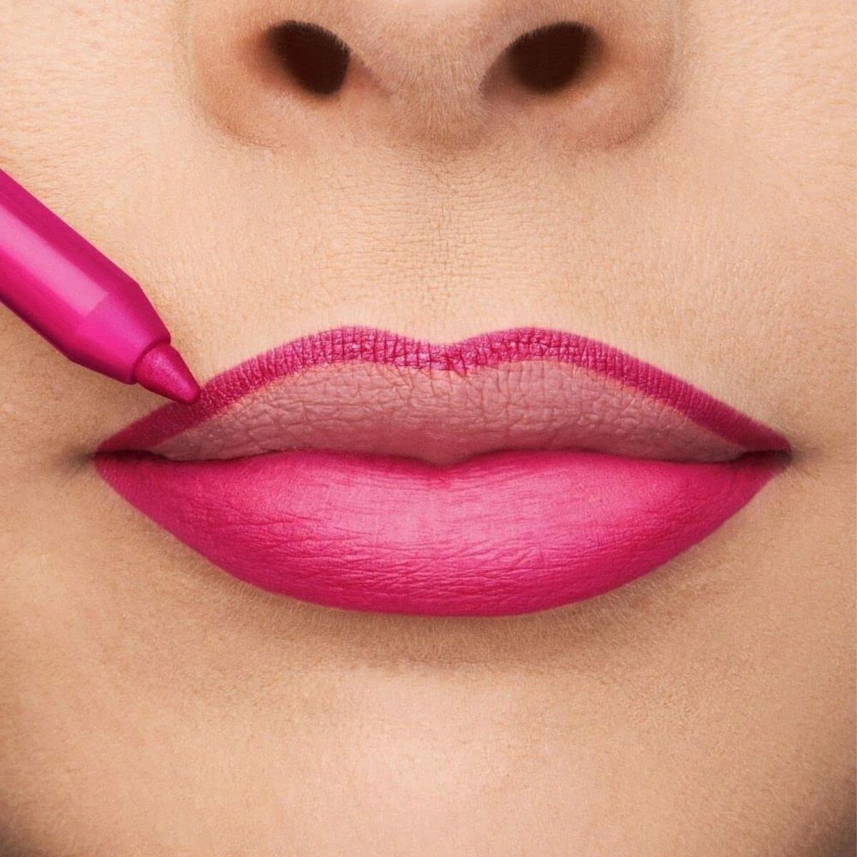 Application of bright pink lipstick on smooth lips, showcasing a bold and vibrant look.