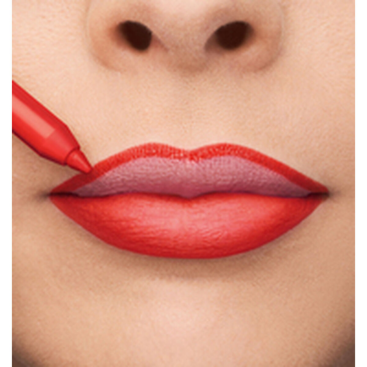 Application of red lipstick on full lips, showcasing precision and vibrant color.