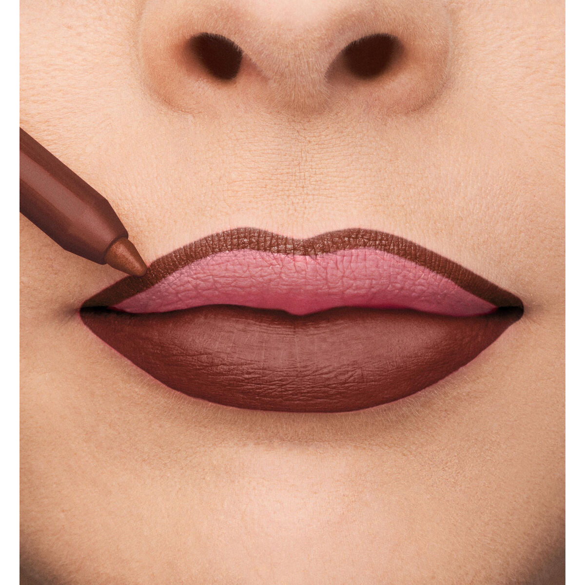 Close-up of lips with lipstick application, showcasing a professional makeup look with browns and pinks.