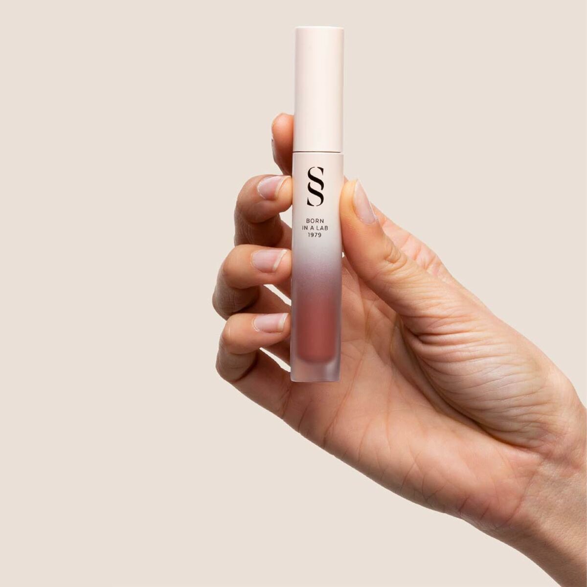 Main image of Sensilis ETERNALIST A.G.E lipstick in hand, showcasing its sleek design and liquid texture.
