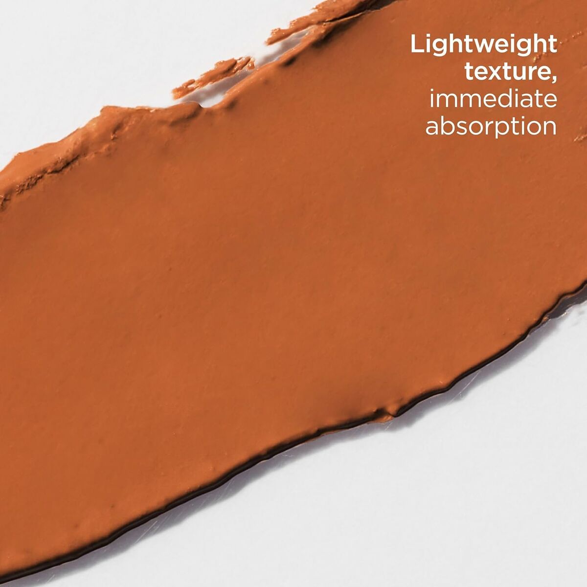 Close-up of lightweight brown makeup texture showing immediate absorption properties.