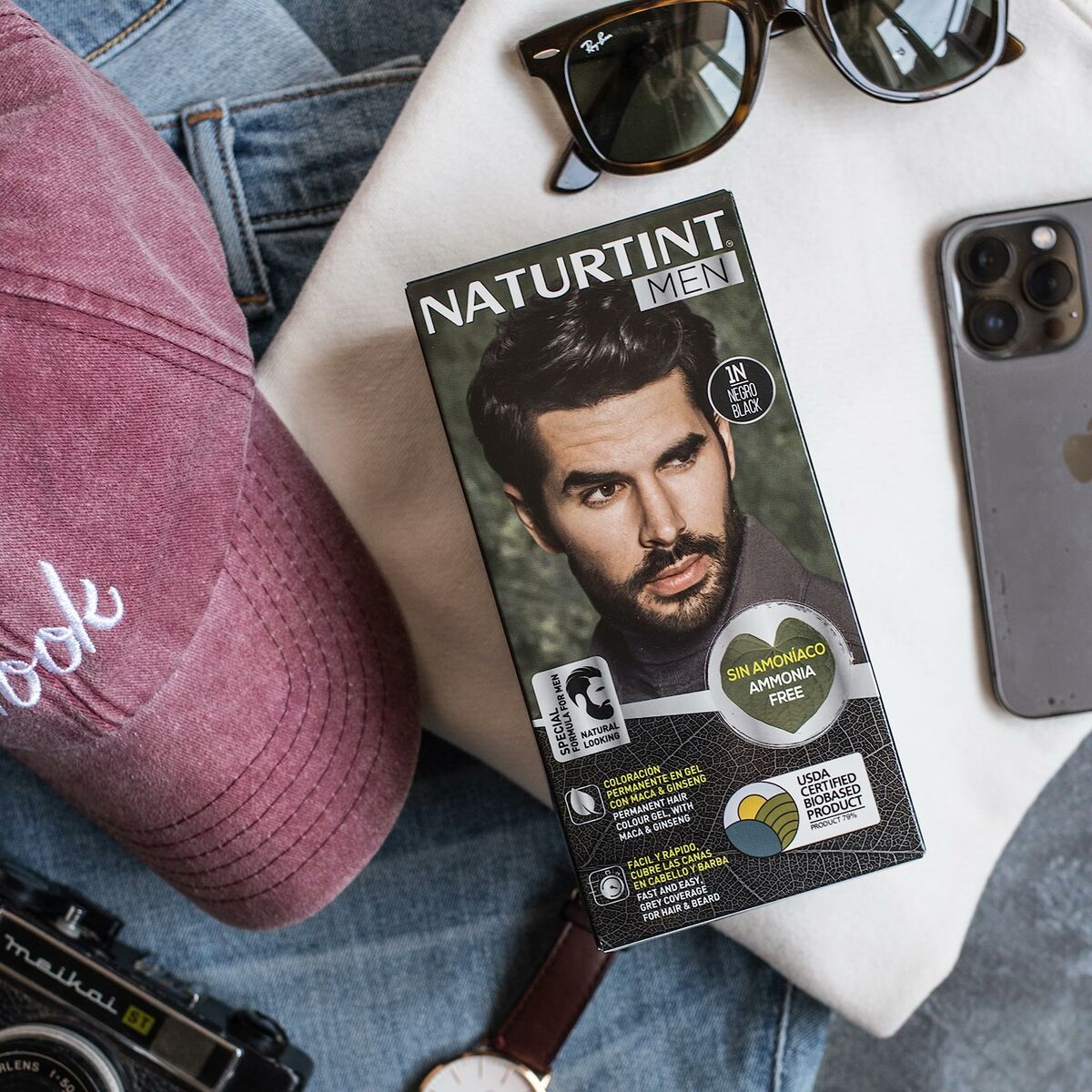 Naturtint Men permanent hair dye 6-rubio oscuro, ammonia-free, stylish packaging with male model, sunglasses, and accessories.