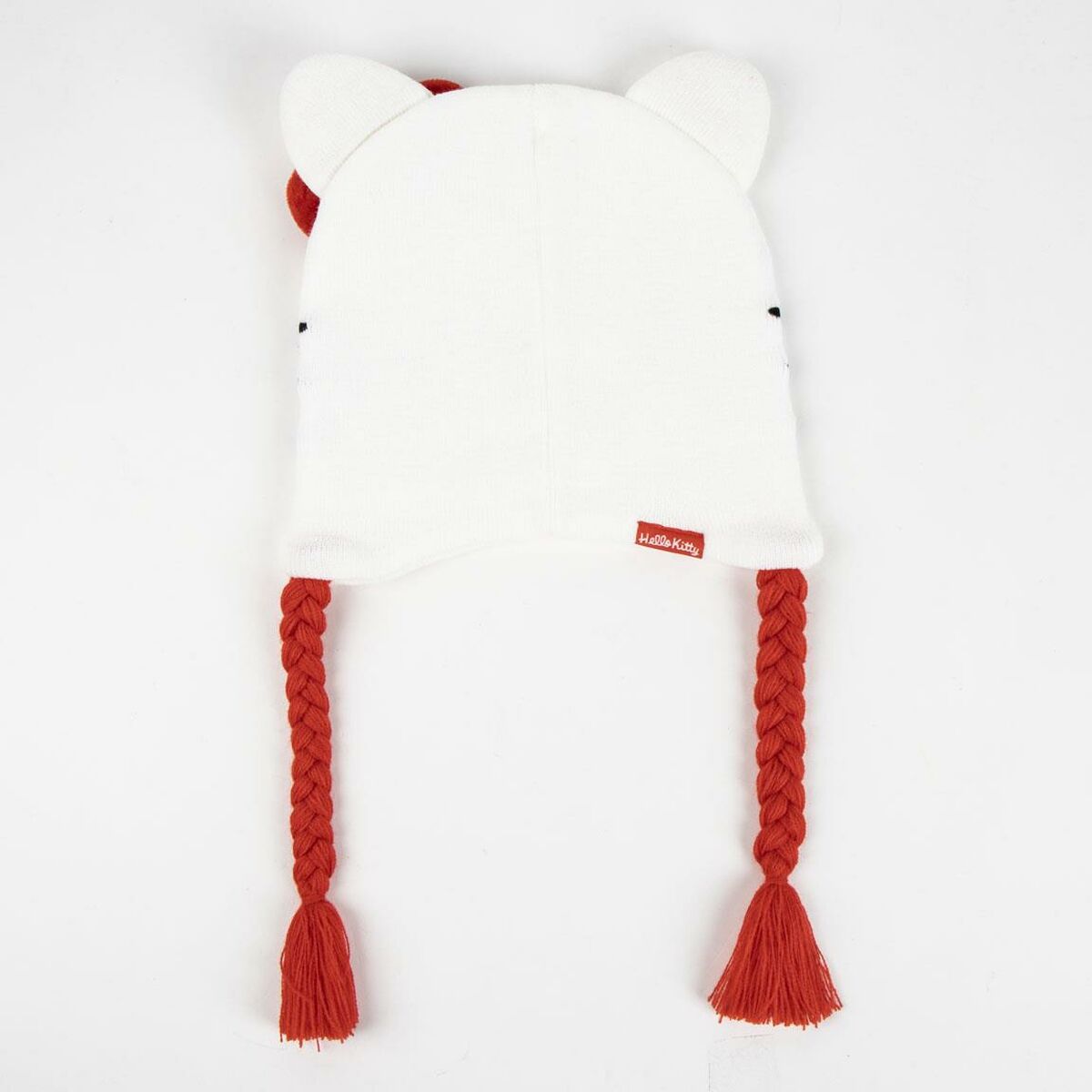 Bonnet de douche Hello Kitty blanc en acrylique avec oreilles, tresses rouges et étiquette Hello Kitty.