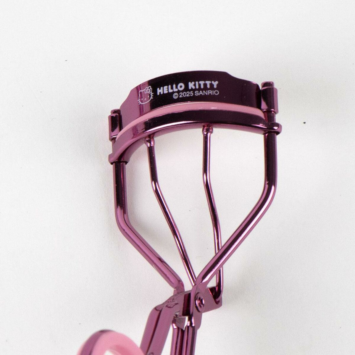 Recourbe-cils Hello Kitty en rose, partie de l'ensemble de beauté 3 pièces pour un look glamour.