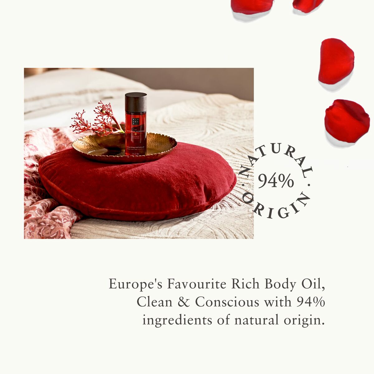 Rich body oil on a red pillow, emphasizing 94% natural ingredients and clean beauty.