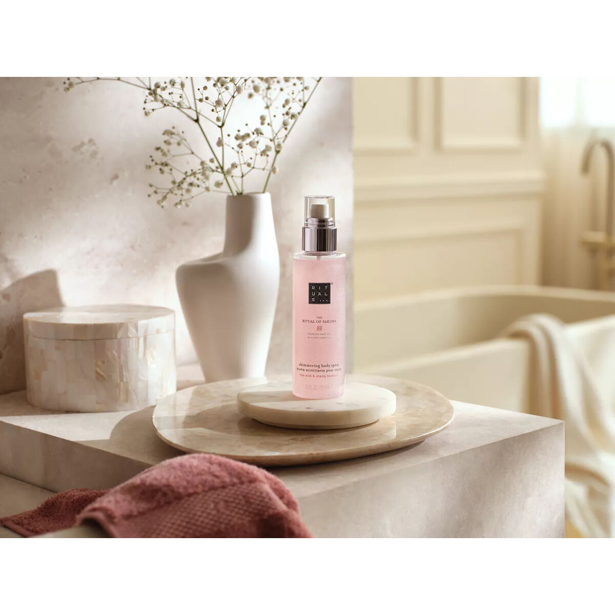 Body Mist Rituals THE RITUAL OF SAKURA 150 ml displayed elegantly on a marble surface with soft textiles.